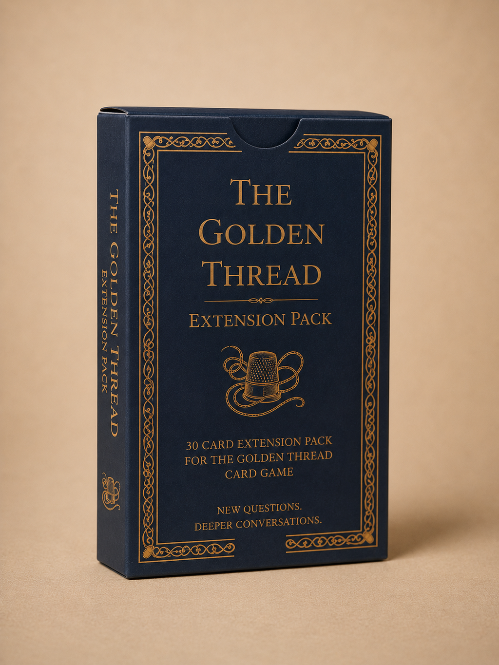 The Golden Thread Card Game Extension Pack box, featuring a dark navy blue cover with ornate gold borders and gold lettering, set against a solid beige background.